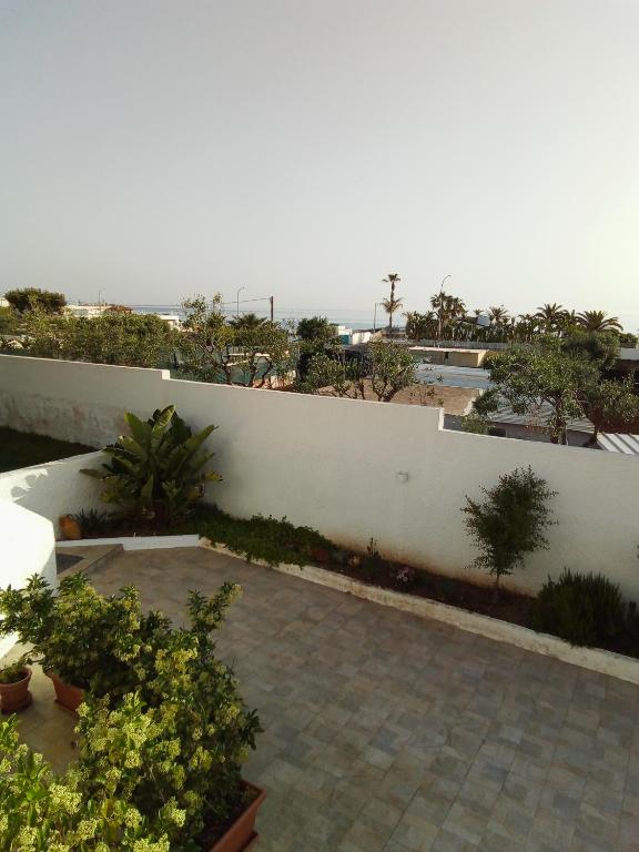 a garden with plants and a white fence at Villa Anna Maria in Polignano a Mare