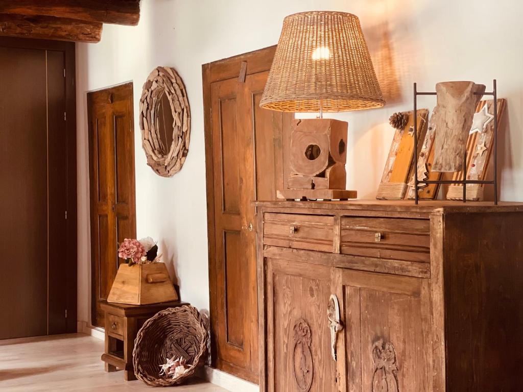 a room with a wooden cabinet with a lamp on it at Casa Valle Duplex de montaña in Panticosa