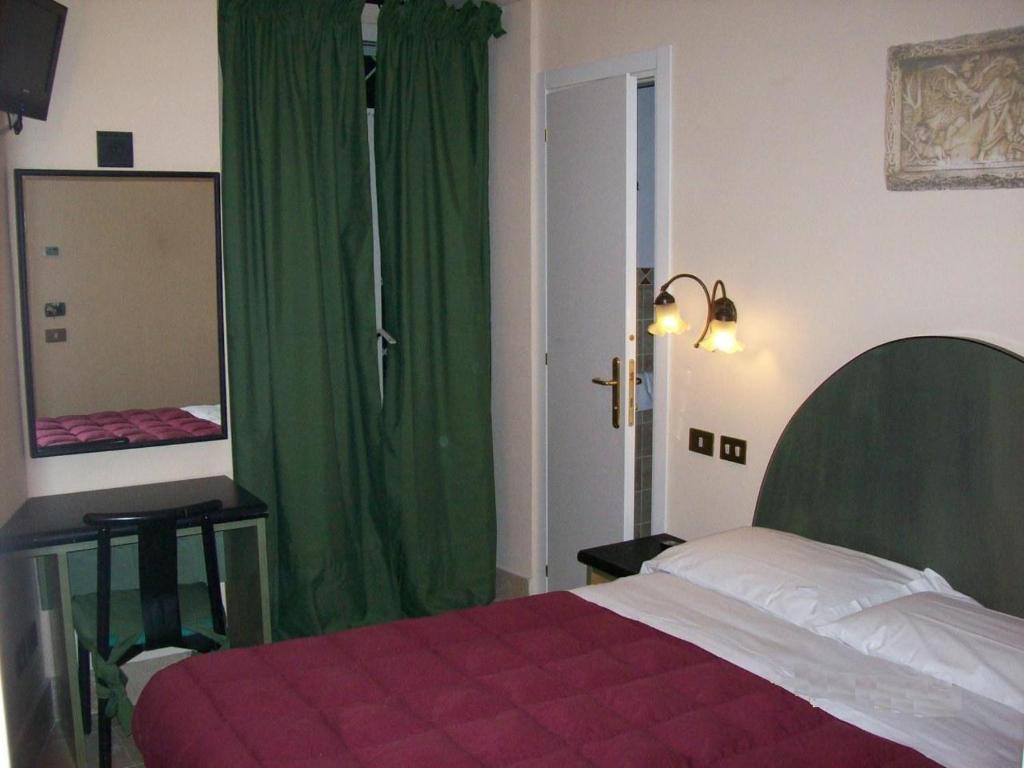 Postel nebo postele na pokoji v ubytování Hotel Prati