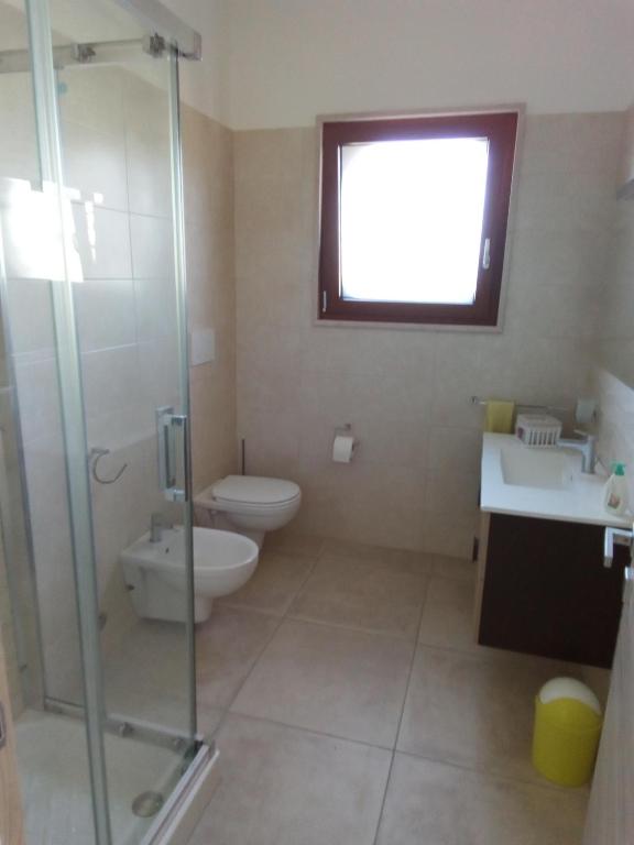 a bathroom with a toilet and a sink and a shower at Villa Anna Maria in Polignano a Mare