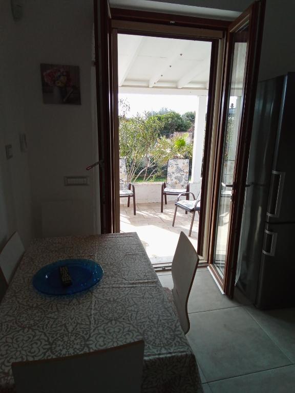 a room with a table and a sliding glass door with a patio at Villa Anna Maria in Polignano a Mare