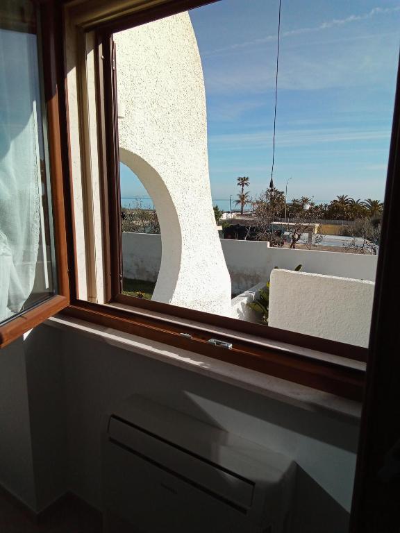 a window with a view of a building at Villa Anna Maria in Polignano a Mare