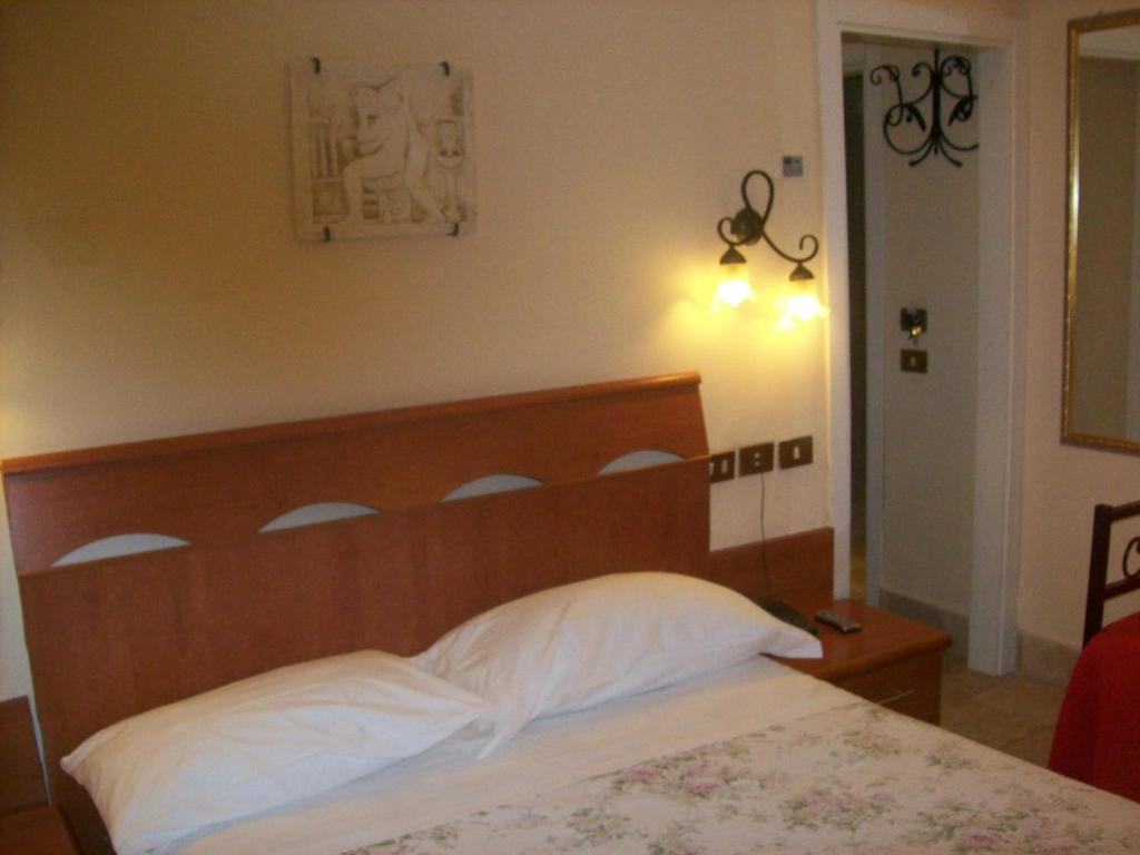 Postel nebo postele na pokoji v ubytování Hotel Prati