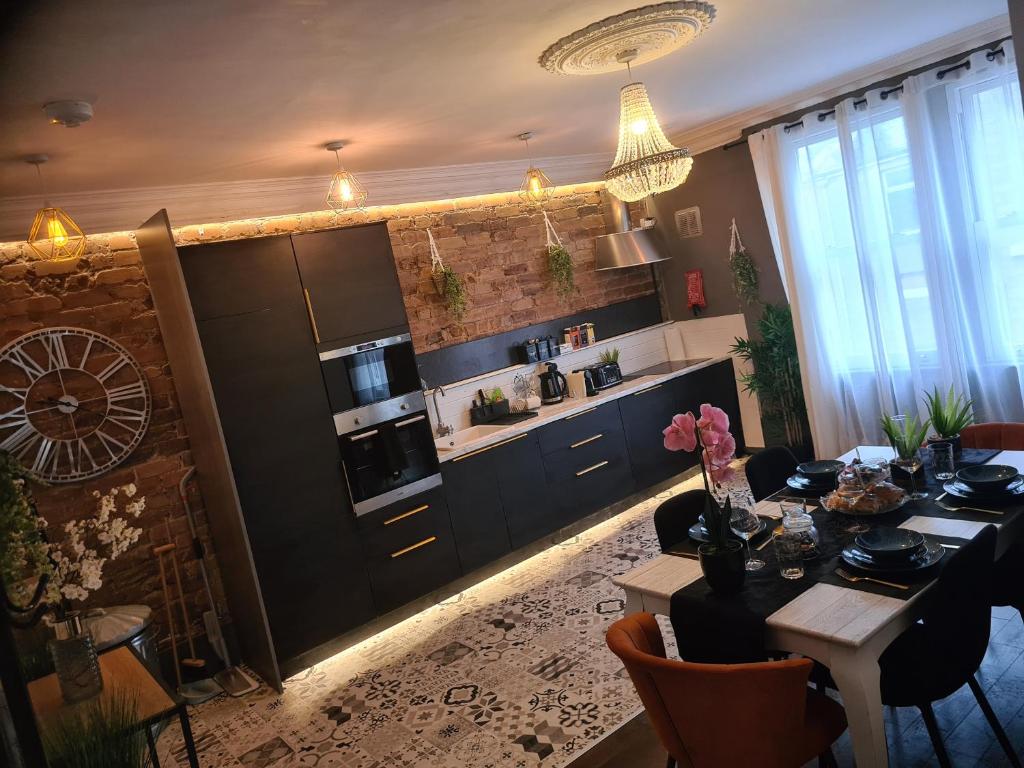 a kitchen with a table and a dining room at Albert Rd Aparthotel in Colne