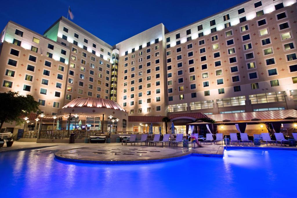 a hotel with a pool in front of a building at Harrah's Gulf Coast Hotel & Casino in Biloxi