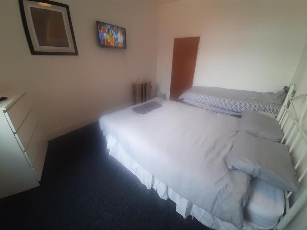 a bedroom with a white bed in a room at Adam letting(s) in Middlesbrough