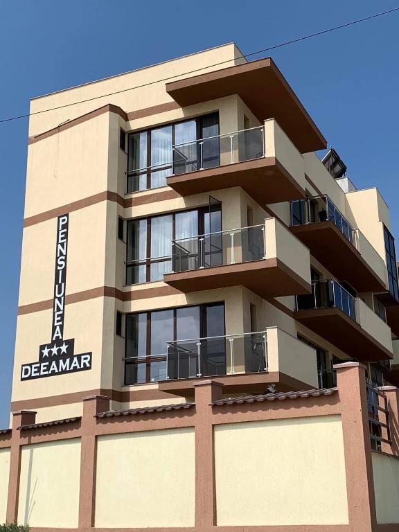 a building with balconies on the side of it at Pensiunea DeeaMar in Năvodari