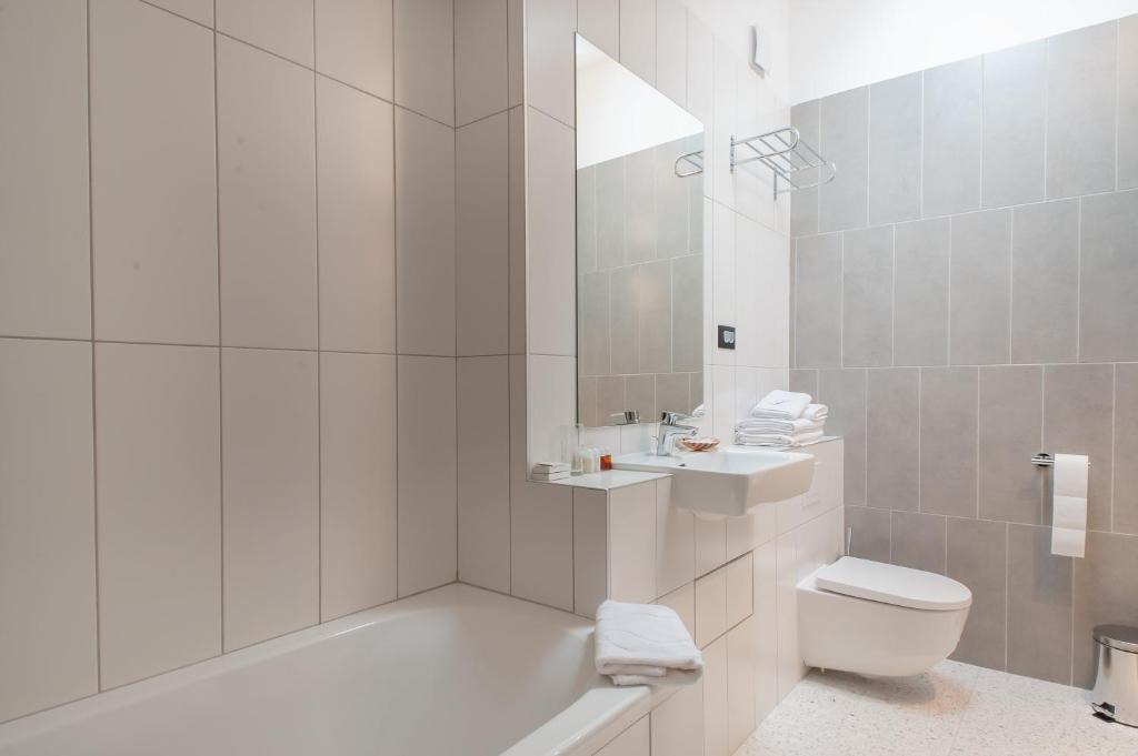 a bathroom with a tub and a toilet and a sink at Boutique hotel Lili in Rovinj