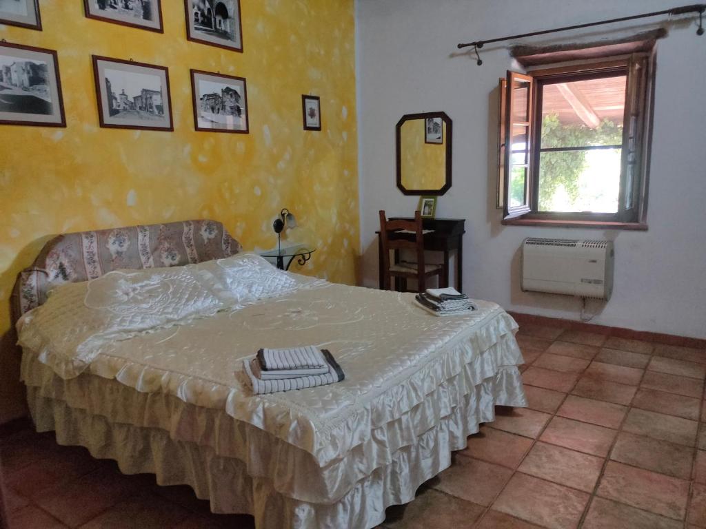 Postel nebo postele na pokoji v ubytování Bio Agriturismo Il Cavone