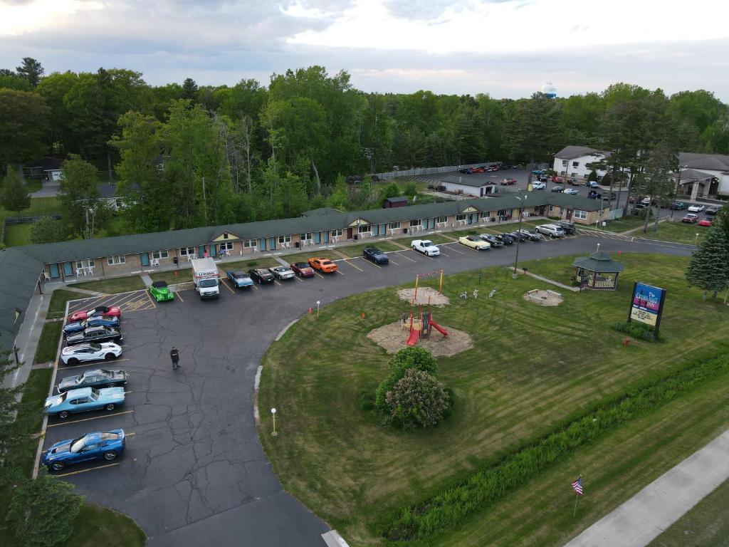 an aerial view of a parking lot with cars parked at Crow's Nest in Tawas City