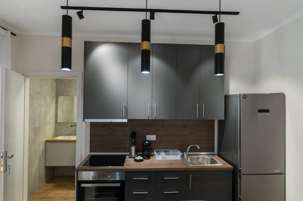 a kitchen with a sink and a refrigerator at Stamatina's Luxury Apartment (Little Suite) in Alexandroupoli