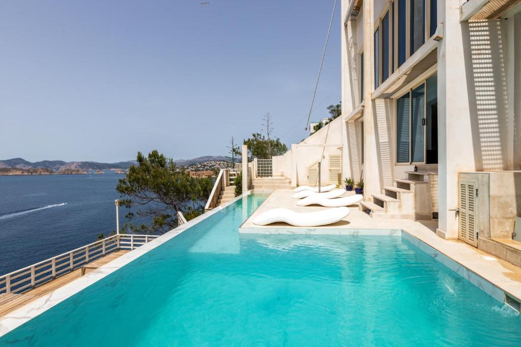 a swimming pool with a view of the water at VIP seafront villa in El Toro