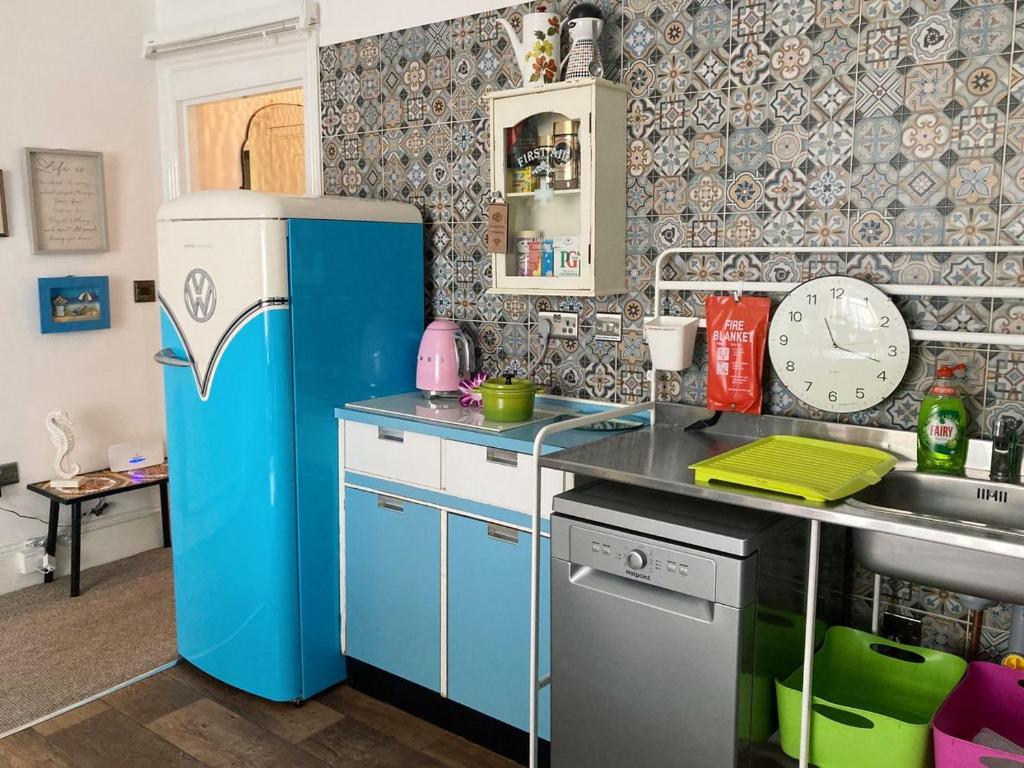 a kitchen with a blue refrigerator and a sink at Enjoy Ventnor 1, Pier Street, Wightlink offer in Ventnor