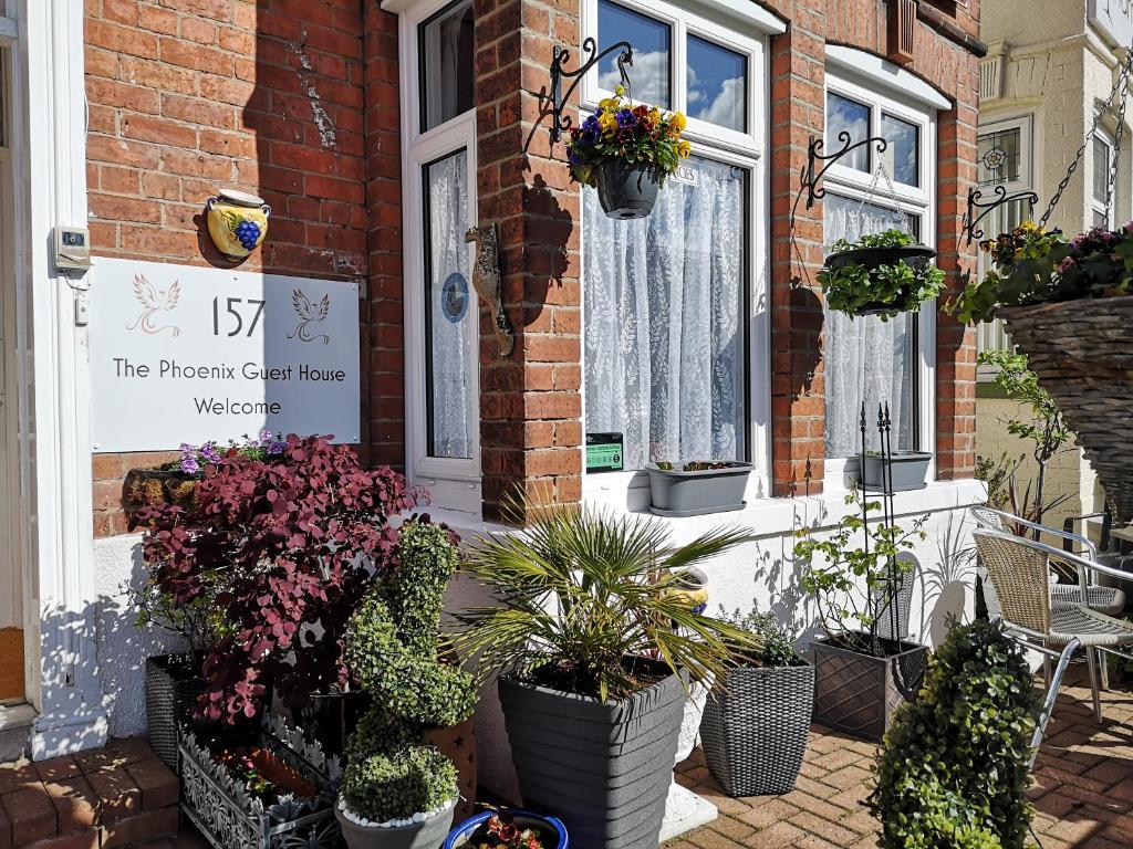 a house with potted plants in front of a door at The Phoenix Guest House in Scarborough