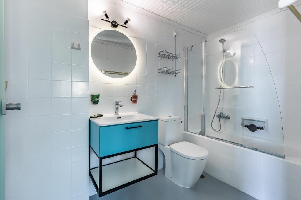 a bathroom with a sink and a toilet and a shower at Panormos Beach Hotel Skopelos in Panormos Skopelos