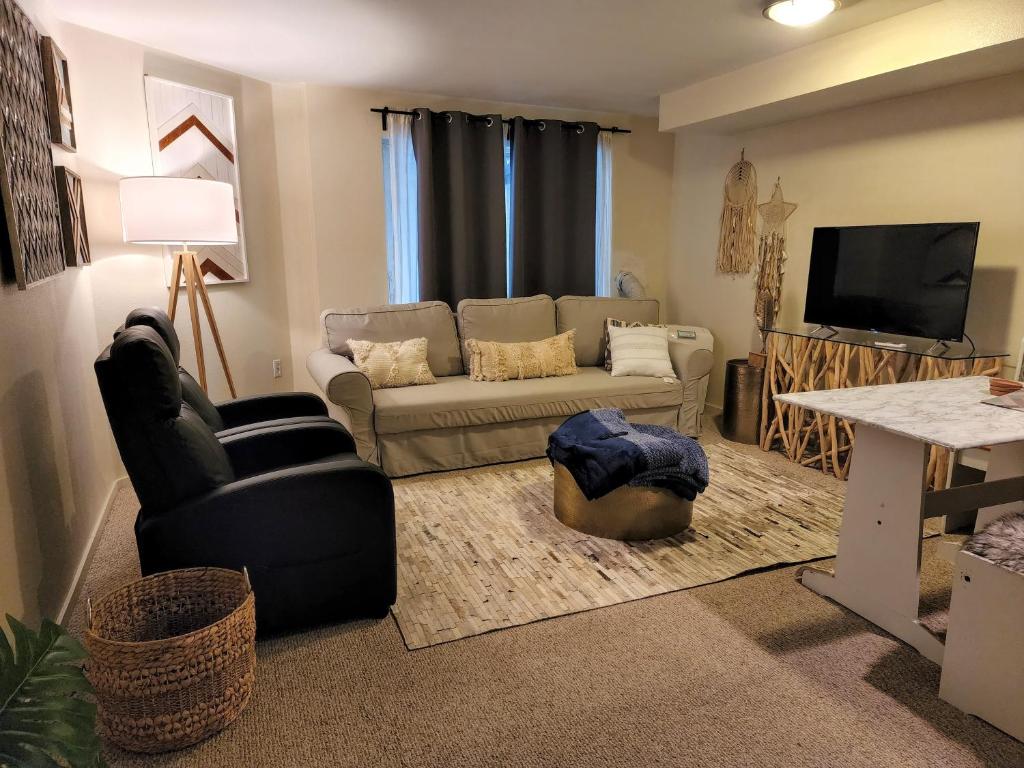 a living room with a couch and a tv at Lovely 1 Bedroom Condo in the Heart of Seattle! in Seattle