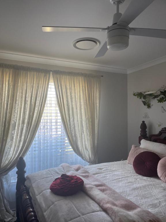 a bedroom with a bed and a window with curtains at Gibbagunyah Manor Workers Accommodation Only in Muswellbrook