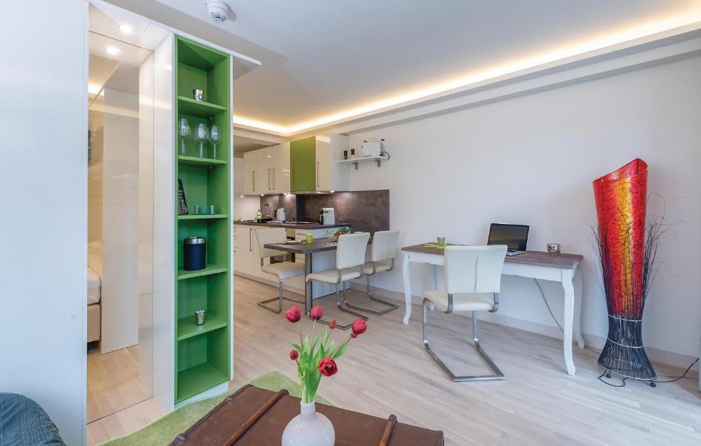 a living room with a table and a green shelf at Baltic in Binz