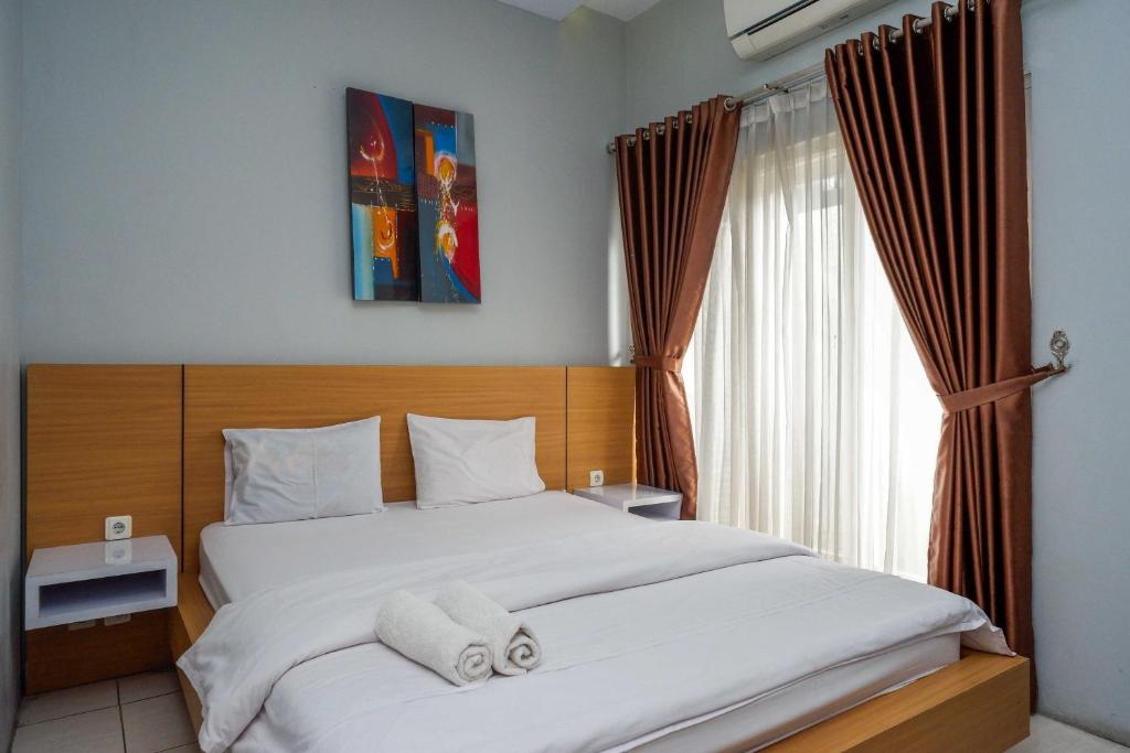 Postel nebo postele na pokoji v ubytování Sans Hotel Absari Yogyakarta