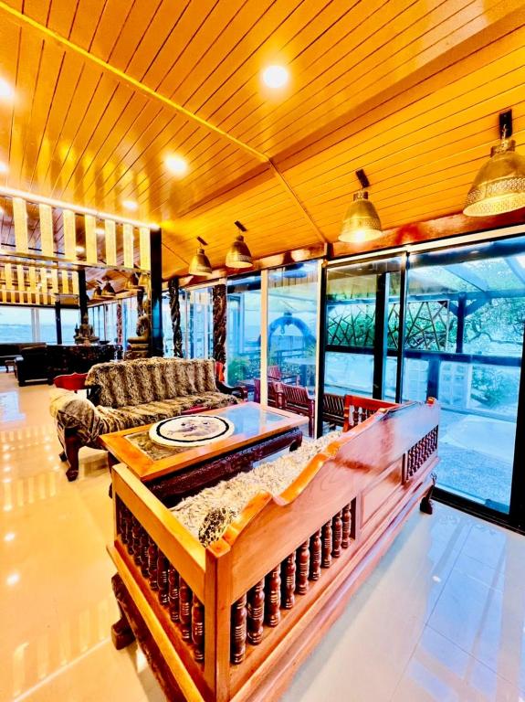 a living room with a couch and a table at Crystal Sea Villa in Ko Larn