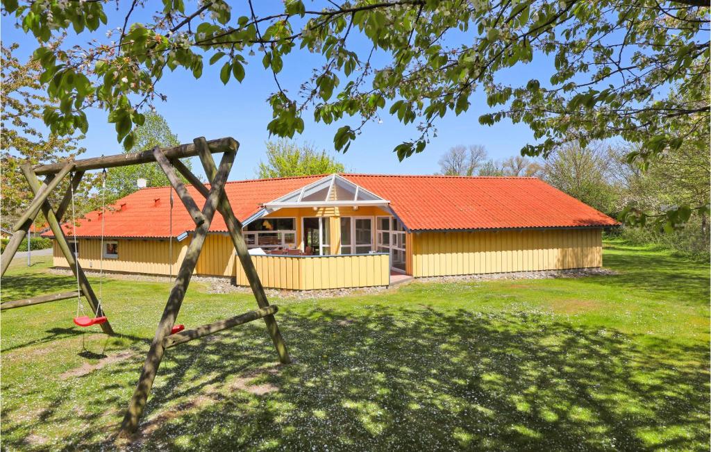 a house with an orange roof and a swing at Poolhaus 1 In Hohendorf in Hohendorf
