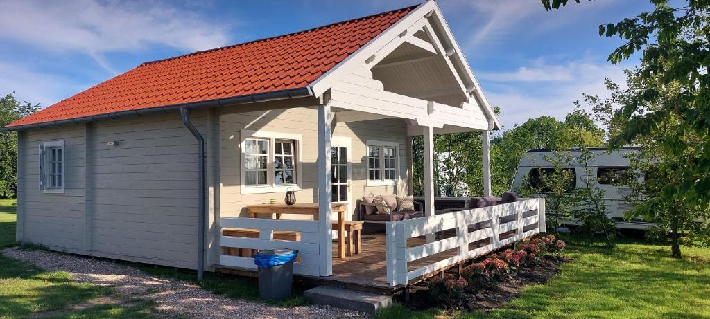 a small white shed with an orange roof at Sleat - Camping Buorren1 in Warstiens
