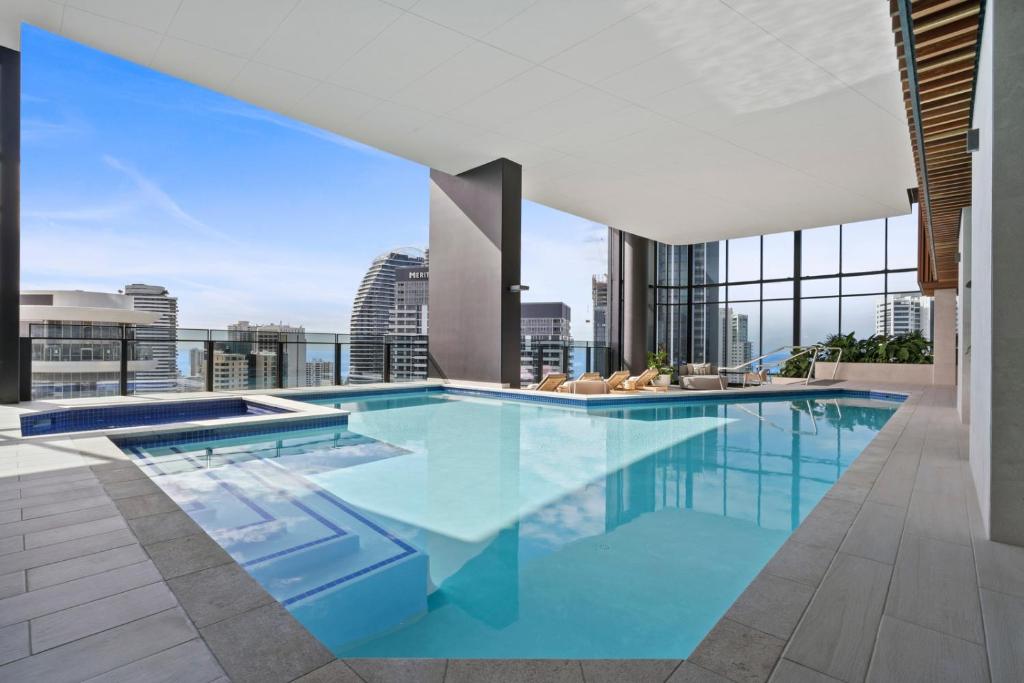 a swimming pool on the roof of a building at Broadbeach Casino Private Apartments - GCLR in Gold Coast