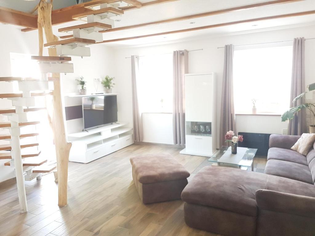 a living room with a couch and a tv at Ferienhaus am Rande des Müritz-Nationalparks in Kargow