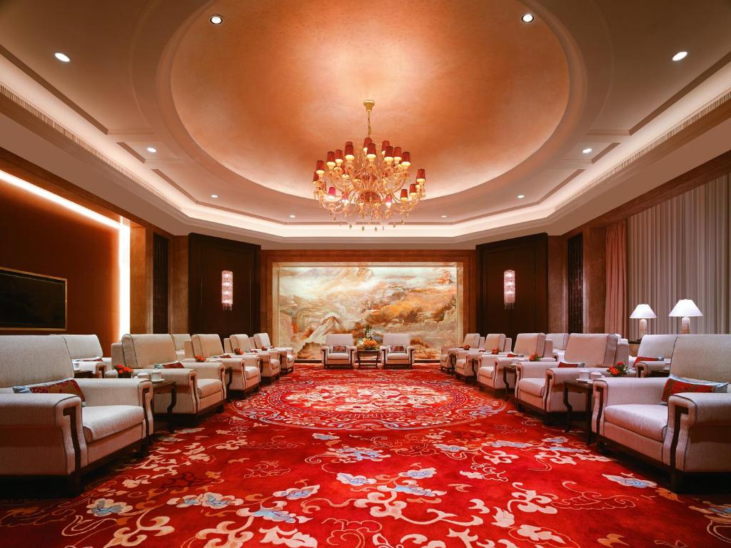 a conference room with chairs and a chandelier at Grand Hotel Haikou - Managed by Accor in Haikou