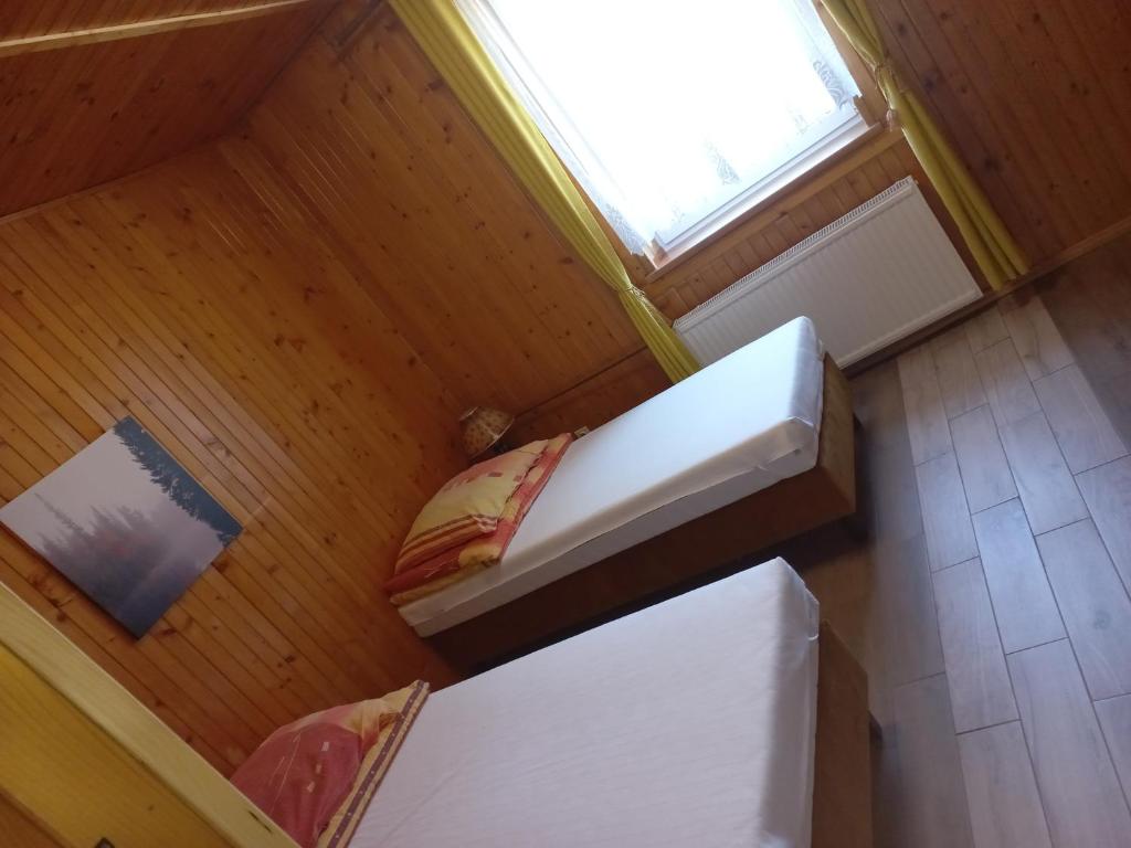 an overhead view of a room with a bed and a window at Holiday Ozon in Sztutowo