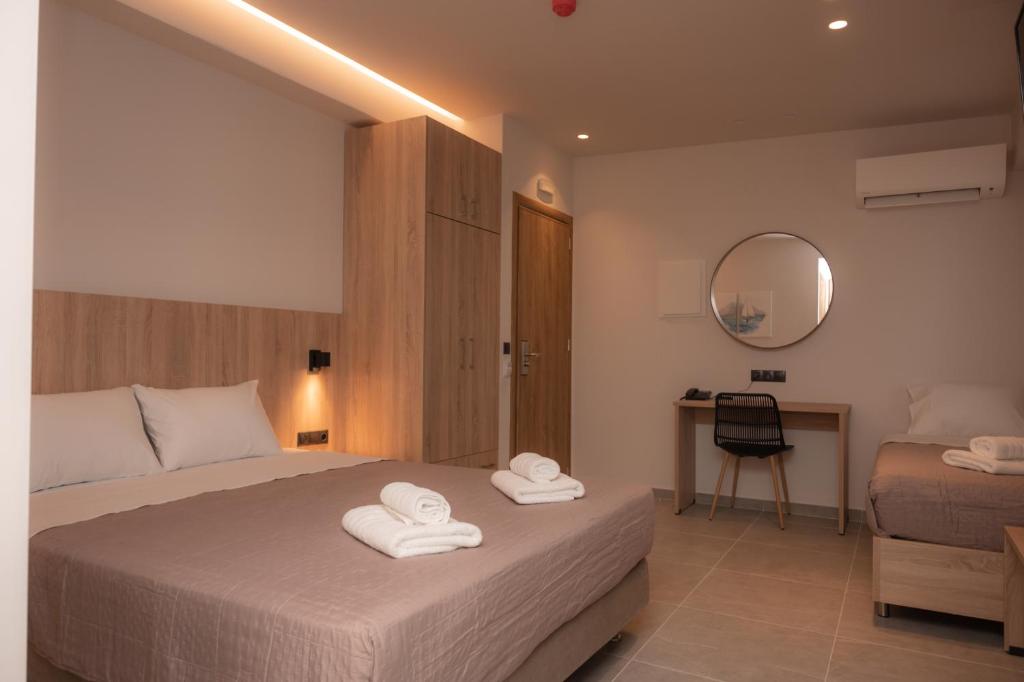 Postel nebo postele na pokoji v ubytování Nomad Hotel Paralia