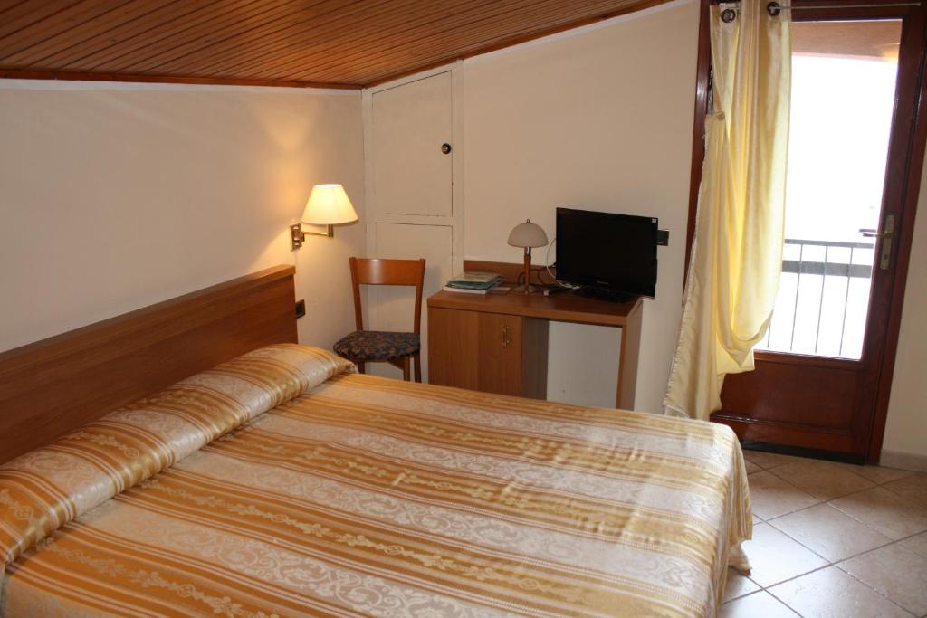 Postel nebo postele na pokoji v ubytování Albergo Ristorante Punta Dell'Est