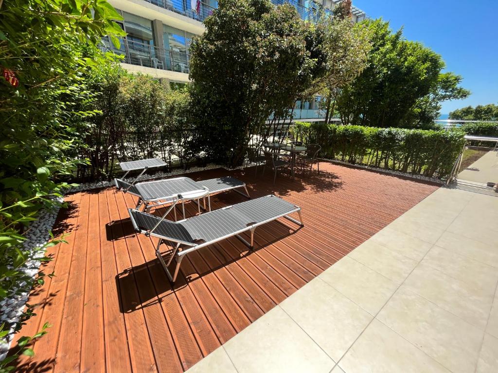 a group of picnic tables on a brick patio at TM Panorama Beach Apartments in Nesebar