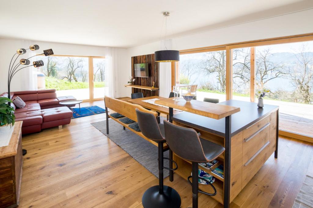 a living room with a table and a couch at Attersee-Chalet Angermann Familie Spalt in Steinbach am Attersee