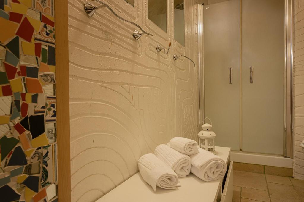 a bathroom with towels on a counter in front of a shower at Dimora 1919 Luxury Loft in Matera
