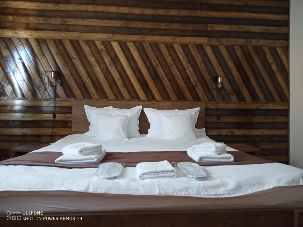 a bedroom with a bed with towels on it at Casa Evanti in Sibiu