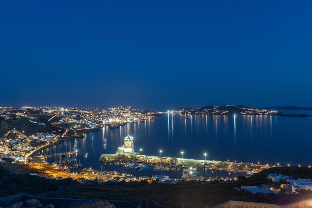 a view of a harbor at night with a city at Villa Almi in Mykonos in Tourlos