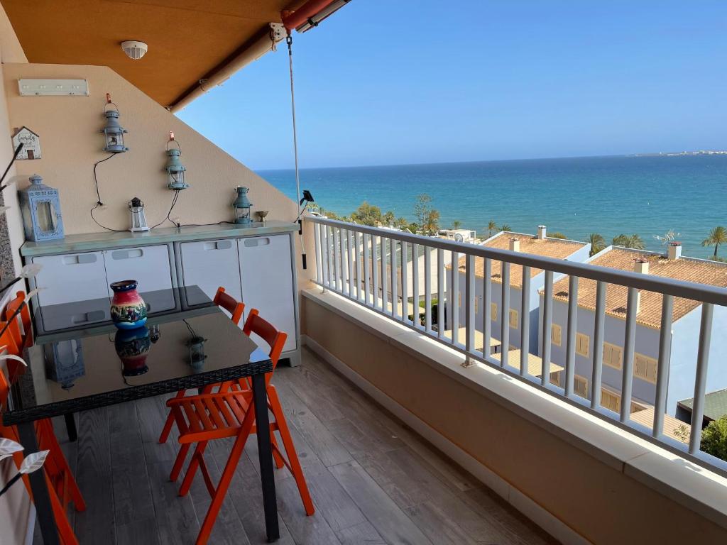 聖波拉的住宿－Apartamento Santa Pola frente al mar，阳台配有桌子,享有海景。