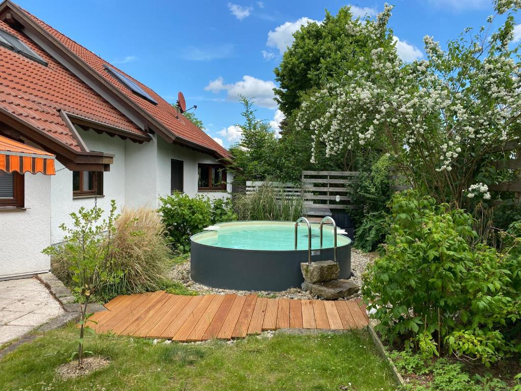 a swimming pool in a yard next to a house at Ferienhaus Elbharmonie in Dresden