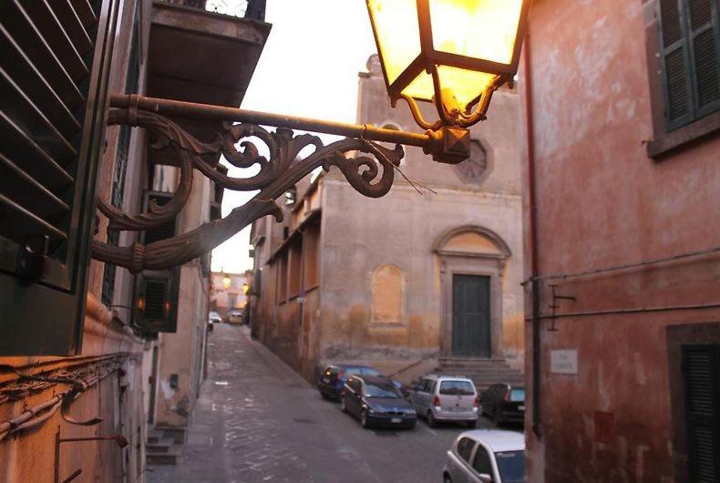 a street with cars parked on the side of a building at La Casa del Buttero in Tuscania
