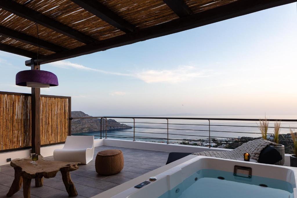 a view of the ocean from a villa with a bath tub at Fedra Suites in Plakias