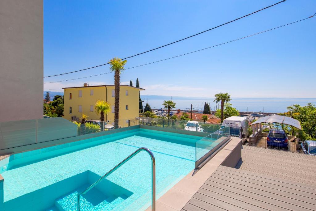 a swimming pool in a villa with a view at Apartments Rona Erea Icici in Ičići