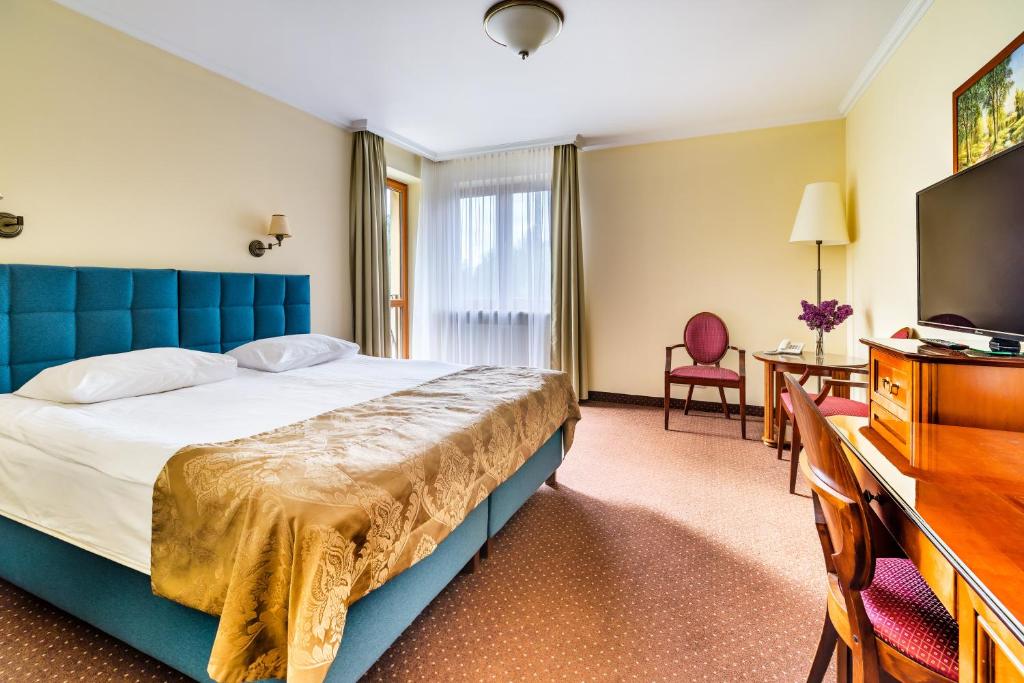 Posteľ alebo postele v izbe v ubytovaní Hotel Pan Tadeusz