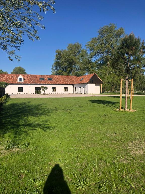 a person standing in a field in front of a building at Touquet's Garden in Cucq