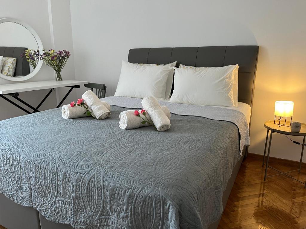 a bedroom with a bed with two stuffed animals on it at Theo Suites in Kavala