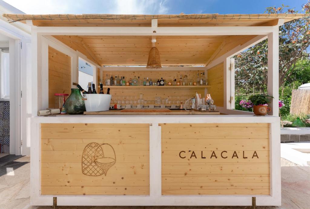 a wooden bar with a sign that says calaza at Cala Cala Rooms,Restaurant & Farm Experience in Procida