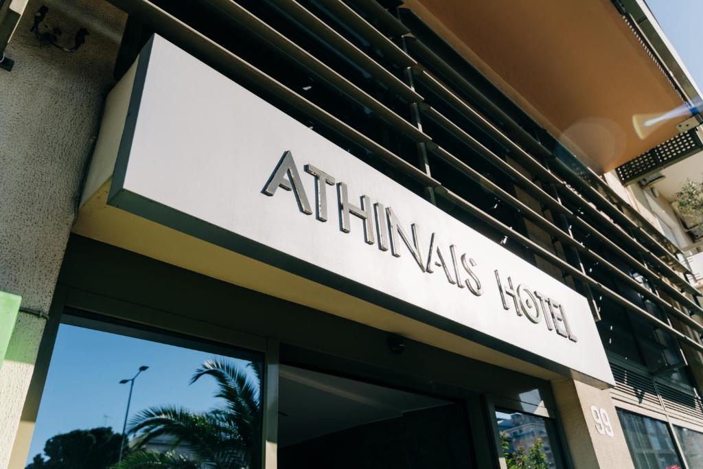 a building with a sign on the front of it at Athinais Hotel in Athens