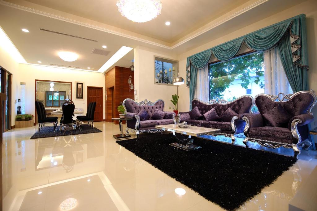 a living room with purple couches and a table at White Palace B&amp;B in Ji&#39;an