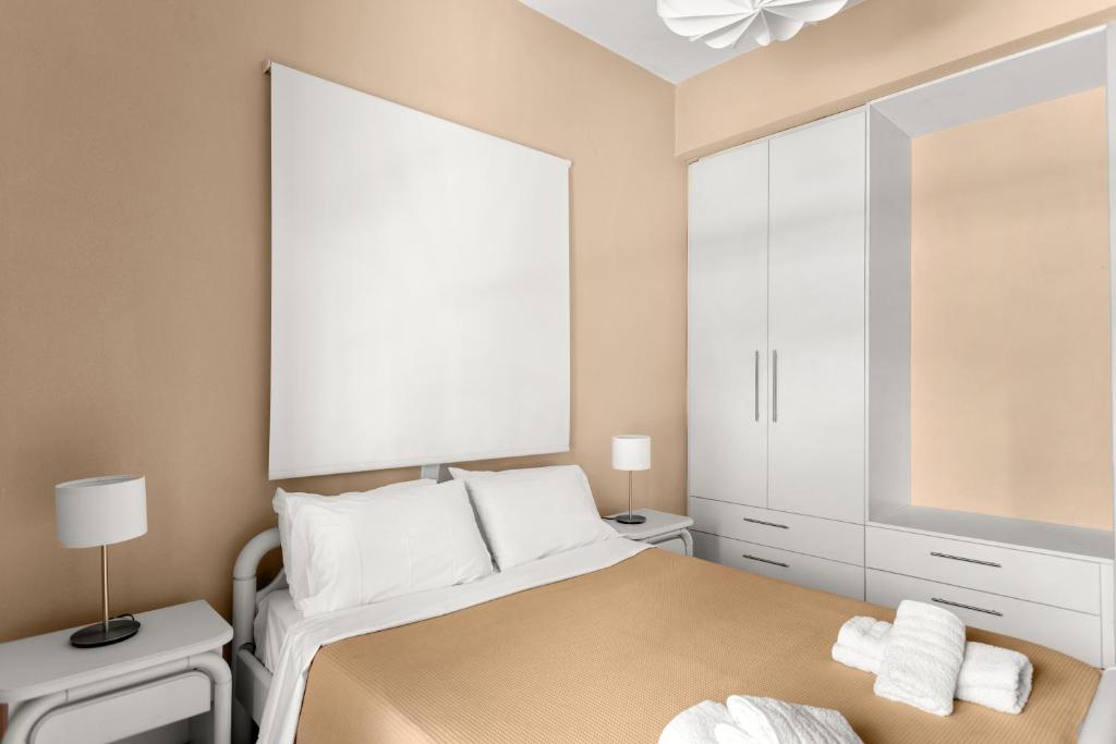 a bedroom with a bed and a large mirror at Dimitra's Studios in Stoupa