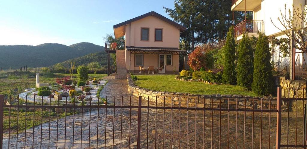 a house with a fence in front of a yard at Villa Silva in Ohrid